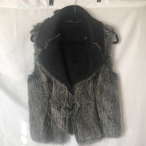 Faux black and white fur vest with black suede. Interchangeable. Size M to L.